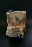Gold, silver and copper colored soap with a D20 dice on top
