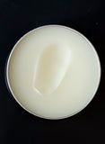 Tattoo balm in  in black tin with texture shown