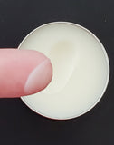 Tattoo balm in  in black tin with texture shown