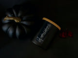 Black  matte pumpkin scented  candle with  bamboo lidEnchanted pumpkin soy  candle in matte black jar with bamboo lid