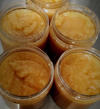 Orange sugar scrub in clear container