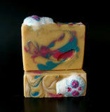 Gold soap with blue and pink swirls, sugar skull on top