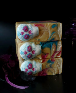Gold soap with blue and pink swirls, sugar skull on top