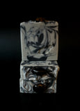 Gray soap with black swirls topped with a smoky quartz crystal