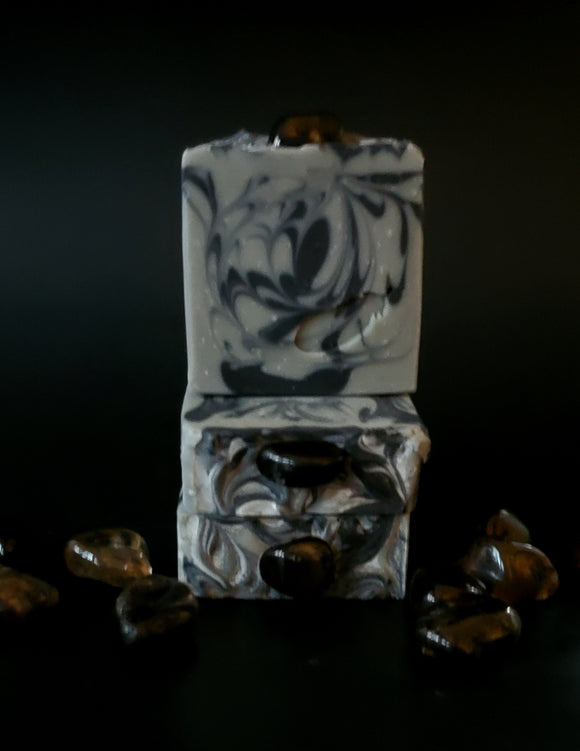 Gray soap with black swirls topped with a smoky quartz crystal