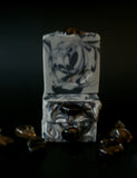 Gray soap with black swirls topped with a smoky quartz crystal