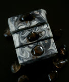 Gray soap with black swirls topped with a smoky quartz crystal