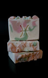 White soap with honey, pink and s age swirls,  Pisces symbol stamped in the middle