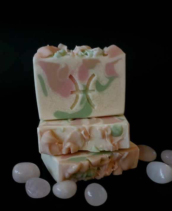 White soap with honey, pink and s age swirls,  Pisces symbol stamped in the middle