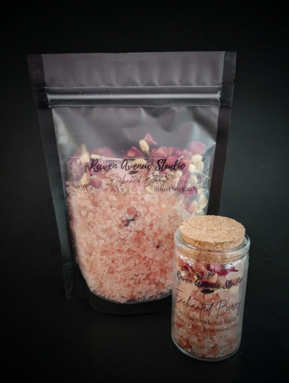 Enchanted Berry Ritual Soaking Salt with dried rose petals and jasmine buds, pictured in black bag and corked jar