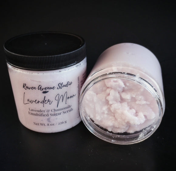 Light purple sugar scrub in clear container with black lid in 8 oz and 4 oz size