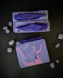 purple soap bar with fuchsia swirls and a purple soap crystals on top with holo glitter