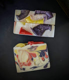 White soap with yellow, red and purple swirl, with witch hats on top