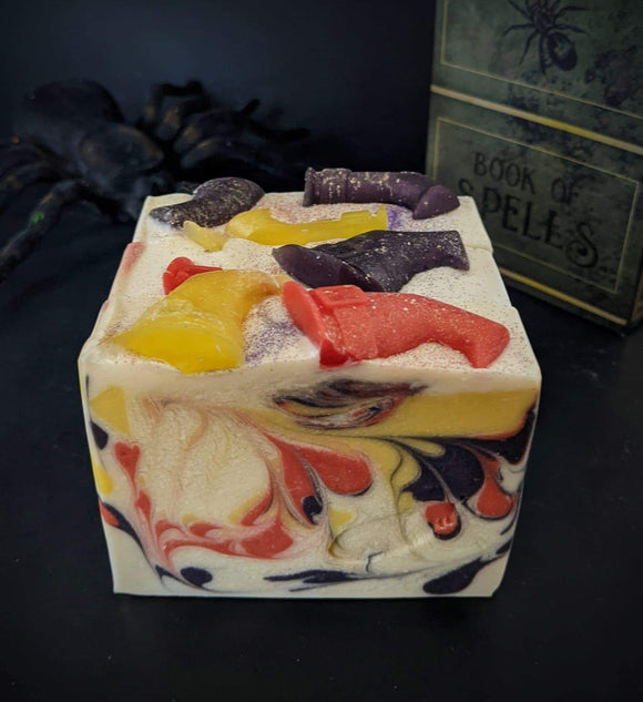 White soap with yellow, red and purple swirl, with witch hats on top